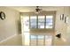 Bright living room with neutral walls, polished floors, and a large window overlooking the outside at 4143 57Th N St # 502, Kenneth City, FL 33709