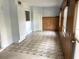Sunroom featuring tile floors, white ceiling and walls, and wood paneling along the exterior wall at 4143 57Th N St # 502, Kenneth City, FL 33709