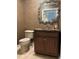 Cozy powder room with vanity, mirror, and wallpaper at 750 4Th S Ave # 601H, St Petersburg, FL 33701