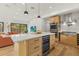 Modern kitchen island with bar seating, stainless steel appliances, and open layout into the living area at 2260 Bay Se St, St Petersburg, FL 33705