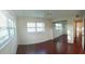 Bedroom with wood floors, large windows, and a mirrored closet, enhancing the sense of space at 6026 22Nd N Ave # 4, St Petersburg, FL 33710