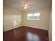 This bedroom features hardwood floors, a ceiling fan, a window and light-colored walls at 6026 22Nd N Ave # 4, St Petersburg, FL 33710