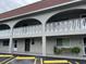 Condo building featuring a neutral color scheme, arched balconies, and well-maintained landscaping at 6026 22Nd N Ave # 4, St Petersburg, FL 33710