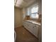 Kitchen showcasing neutral counters and a double basin sink illuminated by a bright window at 6026 22Nd N Ave # 4, St Petersburg, FL 33710