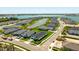 Stunning aerial view of the neighborhood highlighting the lush landscaping around a picturesque lake and the surrounding modern homes at 16397 Preservation Blvd, Punta Gorda, FL 33982