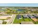An aerial view showcases the home and its neighborhood, complete with golf course, lake, and well-maintained lawns at 16397 Preservation Blvd, Punta Gorda, FL 33982