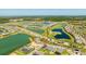 Aerial view of a Primary-planned community featuring homes, lakes, golf courses, and convenient highway access at 16397 Preservation Blvd, Punta Gorda, FL 33982