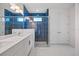 Modern bathroom showcasing dual sinks, stylish lighting, and a luxurious walk-in shower at 16397 Preservation Blvd, Punta Gorda, FL 33982