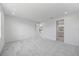 Open bedroom with a view into a kitchen and bathroom, carpeted floors, and white walls at 16397 Preservation Blvd, Punta Gorda, FL 33982