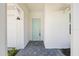 Clean entryway with a blue front door and modern lighting fixtures. and a patterned stone walkway at 16397 Preservation Blvd, Punta Gorda, FL 33982