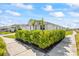 Side view of a well-maintained single-Gathering home with trimmed shrubs and healthy green lawn at 16397 Preservation Blvd, Punta Gorda, FL 33982