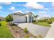 Beautiful single-Gathering home featuring a paver driveway, complemented by verdant landscaping and blue skies at 16397 Preservation Blvd, Punta Gorda, FL 33982