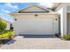 Attached two-car garage featuring a clean white door, matching the house's architectural style at 16397 Preservation Blvd, Punta Gorda, FL 33982