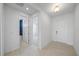 Bright hallway with neutral-toned tile, white walls, and access to a stylish bathroom at 16397 Preservation Blvd, Punta Gorda, FL 33982