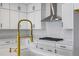 Close-up of kitchen showcasing elegant white cabinetry, countertops, and a modern faucet at 16397 Preservation Blvd, Punta Gorda, FL 33982