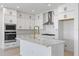 Contemporary kitchen with white cabinets, stainless appliances, island, and plenty of counter space at 16397 Preservation Blvd, Punta Gorda, FL 33982