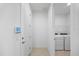 Functional laundry room with washer, dryer, and tile flooring, offering convenience at 16397 Preservation Blvd, Punta Gorda, FL 33982