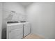 Well-equipped laundry area featuring a modern washer and dryer set with a storage shelf at 16397 Preservation Blvd, Punta Gorda, FL 33982