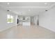 View of the open living room space and the kitchen with island, tile floors and recessed lighting at 16397 Preservation Blvd, Punta Gorda, FL 33982