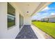 Covered patio with stone flooring, with green grass and a fenced yard at 16397 Preservation Blvd, Punta Gorda, FL 33982