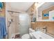 Well-lit bathroom with a glass enclosed shower and decorative nautical accents at 1768 Suffolk Dr, Clearwater, FL 33756