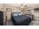 Comfortable bedroom with a ceiling fan, neutral walls, and tile flooring at 1768 Suffolk Dr, Clearwater, FL 33756