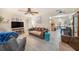 Open-concept living room with tile floors, ceiling fan, comfortable seating and beach decor at 1768 Suffolk Dr, Clearwater, FL 33756