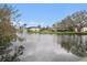 Scenic lakeside view of the community buildings by the pond featuring a fountain at 1768 Suffolk Dr, Clearwater, FL 33756