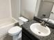 Cozy bathroom featuring a tiled tub/shower, white toilet, vanity with granite countertop and modern faucet at 6113 Shadowlake Dr, Apollo Beach, FL 33572