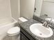 Bright bathroom featuring a tub, toilet, and vanity with granite countertop and a modern faucet at 6113 Shadowlake Dr, Apollo Beach, FL 33572