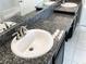 Bathroom vanity featuring granite countertops, double sinks, a mirror, and modern fixtures at 6113 Shadowlake Dr, Apollo Beach, FL 33572