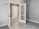 Bedroom features tile floors and double doors at 6113 Shadowlake Dr, Apollo Beach, FL 33572