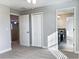 Spacious bedroom with gray walls, carpet flooring, closet, and access to the bathroom at 6113 Shadowlake Dr, Apollo Beach, FL 33572