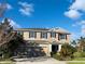 Charming two-story home with three-car garage and well-manicured landscaping on a sunny day at 6113 Shadowlake Dr, Apollo Beach, FL 33572