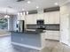 Open kitchen featuring white cabinetry, granite countertops, stainless appliances, and modern pendant lighting at 6113 Shadowlake Dr, Apollo Beach, FL 33572