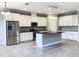 Beautiful kitchen with white cabinets, stainless steel appliances, a center island, and tiled flooring at 6113 Shadowlake Dr, Apollo Beach, FL 33572