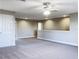 Open loft area with carpet flooring, neutral walls, and a ceiling fan at 6113 Shadowlake Dr, Apollo Beach, FL 33572