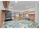 Modern kitchen with wood cabinets, sleek countertops, a stylish backsplash, and open shelving at 12467 94Th Ave, Seminole, FL 33772