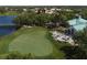 Aerial view of a meticulously manicured putting green and clubhouse with outdoor dining at 5011 88Th E St, Bradenton, FL 34211