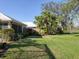 Spacious lawn backing onto a golf course surrounded by mature trees and landscaping at 5011 88Th E St, Bradenton, FL 34211