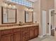 Bathroom featuring double sinks, granite countertops, and classic wooden cabinetry at 5011 88Th E St, Bradenton, FL 34211