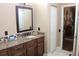 Bathroom featuring granite countertops, dark wood cabinets, and a framed mirror at 5011 88Th E St, Bradenton, FL 34211
