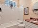 Bathroom with white tile, a shower/tub combo and vanity with granite countertop at 5011 88Th E St, Bradenton, FL 34211