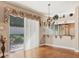 Dining room with chandelier, bar pass-through and sliding glass doors to the patio at 5011 88Th E St, Bradenton, FL 34211