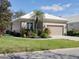 Charming home features an attached garage, manicured lawn, and mature landscaping at 5011 88Th E St, Bradenton, FL 34211