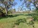 Lush green golf course showcasing manicured lawns and mature trees under a clear blue sky at 5011 88Th E St, Bradenton, FL 34211