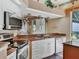 Well-equipped kitchen boasting stainless steel appliances, granite countertops, and custom white cabinetry at 5011 88Th E St, Bradenton, FL 34211