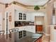 Bright kitchen features white cabinets, a black counter top and red granite counter tops, with decorative touches at 5011 88Th E St, Bradenton, FL 34211