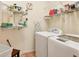 Well-equipped laundry room with storage shelving and modern washer and dryer units at 5011 88Th E St, Bradenton, FL 34211
