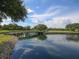 Scenic pond view with lush greenery reflecting trees and sky at 5011 88Th E St, Bradenton, FL 34211